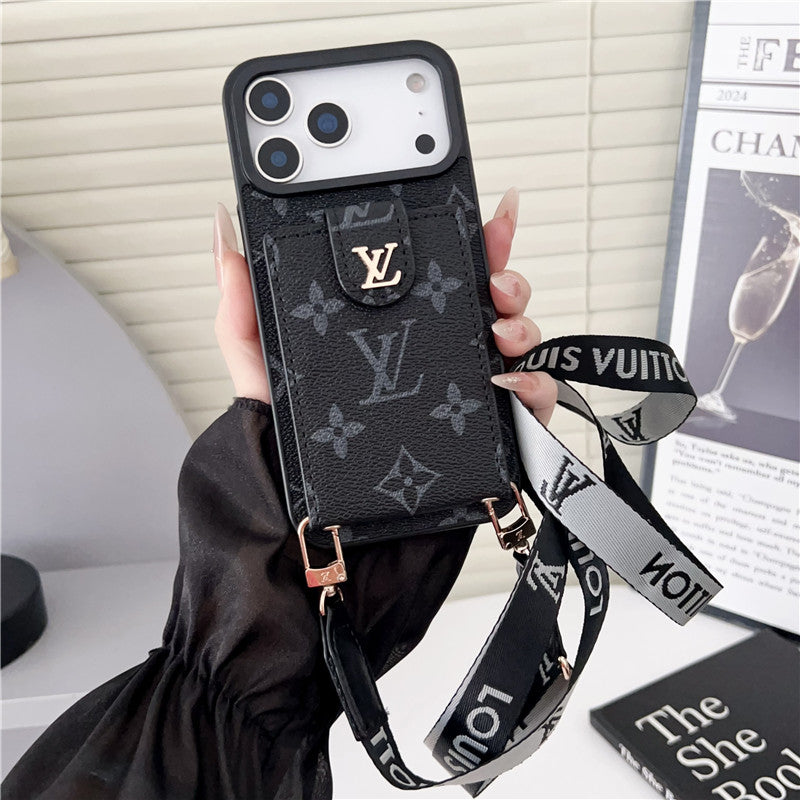Louis Vuitton phone case with strap held by a hand, with a magazine in the background.