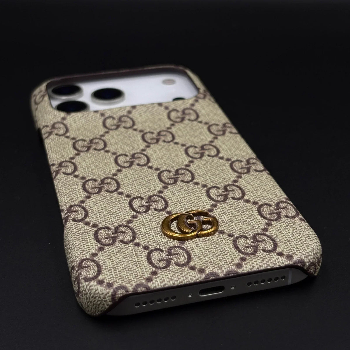 Luxury Gucci GG canvas iPhone 17 Pro Max case in hand – slim fit back cover view | NUVALOVA